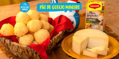 Pão de Queijo Mineiro Imagem da receita de pão de queijo servido em uma cesta ao lado de um queijo e de uma galinha azul