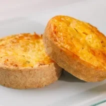 Fotografia de dois salgados assados feitos com massa podre e recheio cremoso de Requeijão NESTLÉ, champignon e cebolinha.